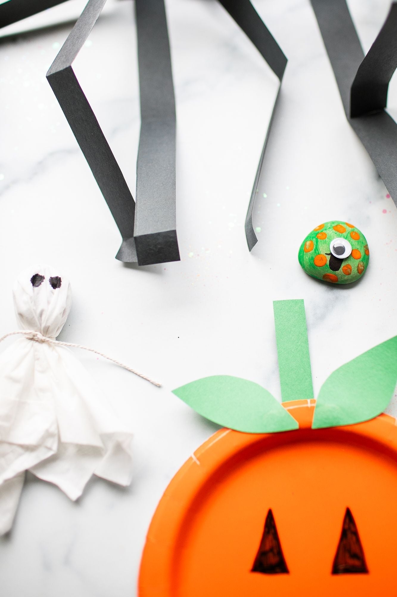 Multiple halloween crafts layed out on a counter