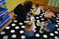 Load image into Gallery viewer, Painted White Dots on Black Classroom Rug by Schoolgirl Style