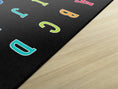 Load image into Gallery viewer, Rainbow Alphabet on Black Sit Spots Rug