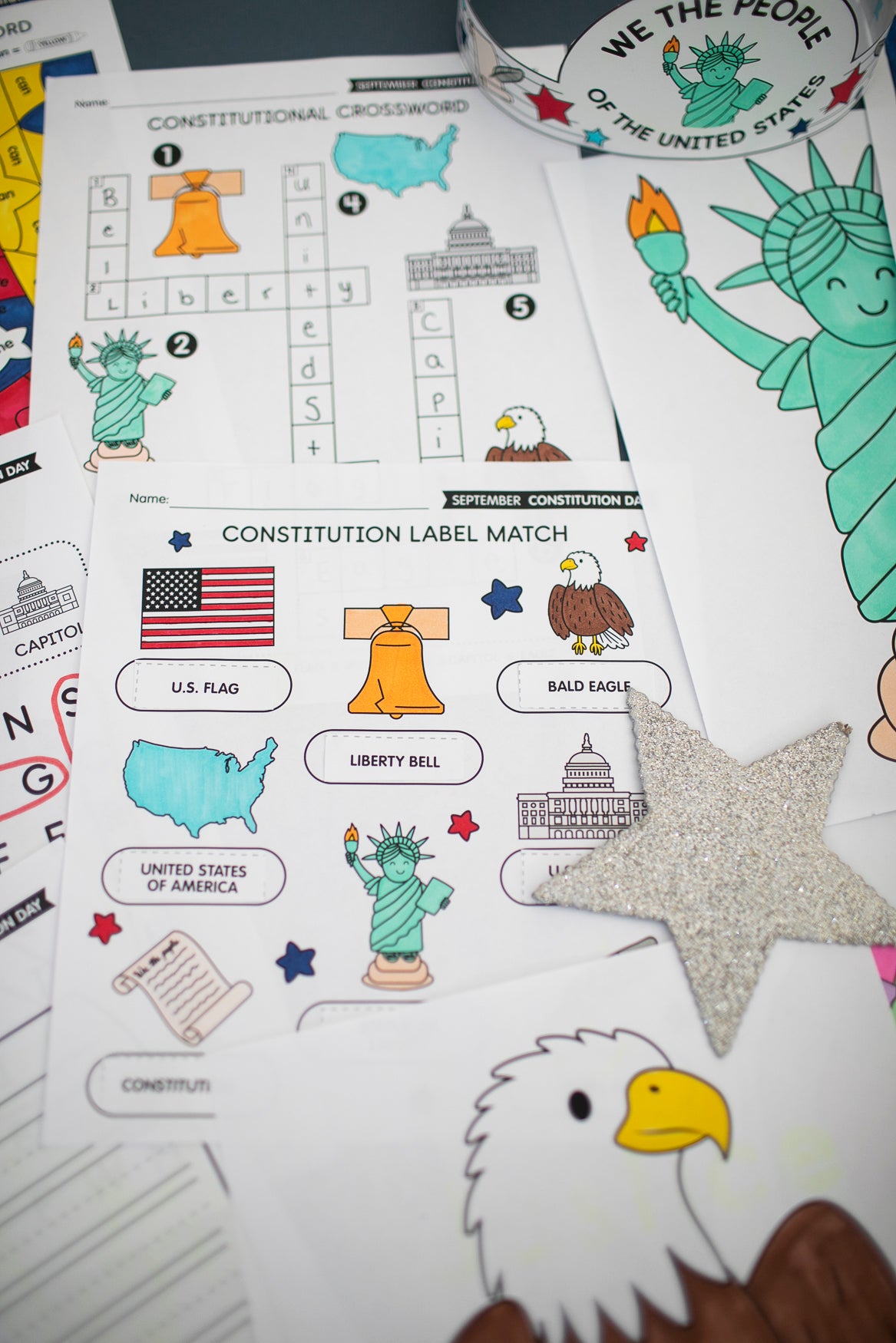 Educational materials about the Constitution with illustrations of the Statue of Liberty, bald eagle, and U.S. flag.