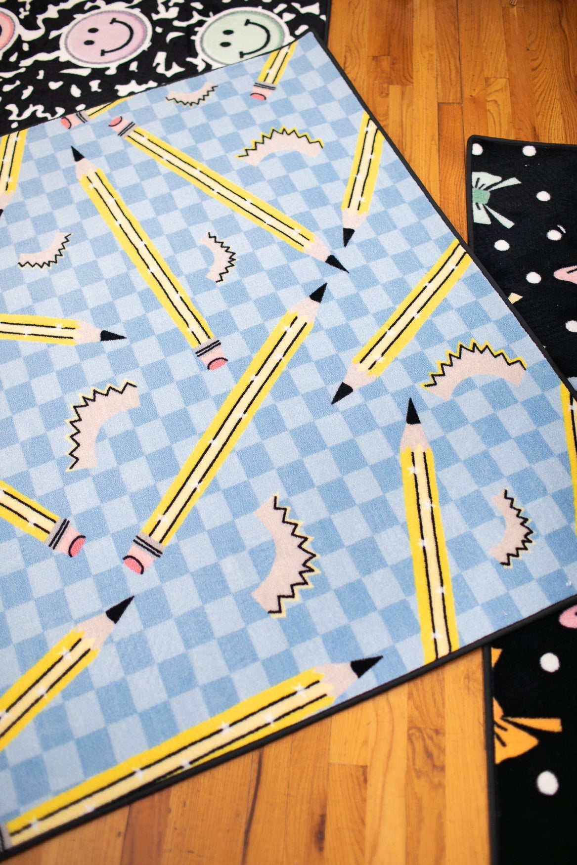 Pencils on Blue Checkerboard Rug