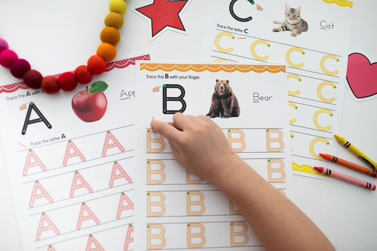 Childs hand pointing to letters