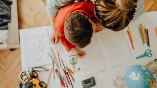 Mother and son completing homeschool tasks