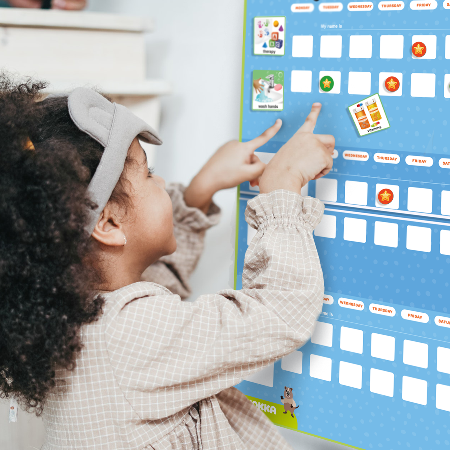 Girl pointing to Magnetic Visual Schedule Board for Kids