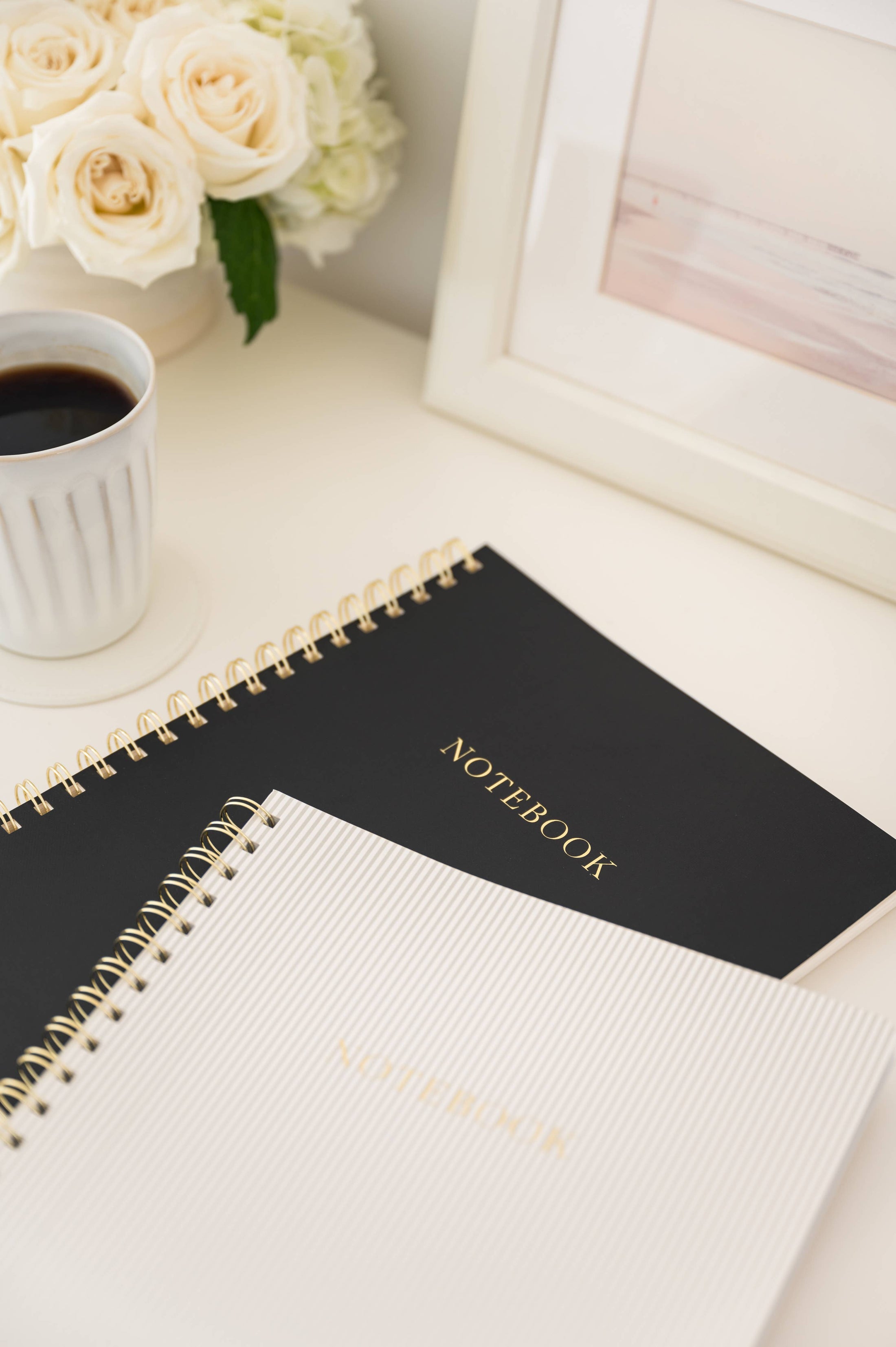 Large Black Spiral Notebook on table 