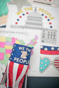 Load image into Gallery viewer, Decorative item with 'We the People' text and American flag design on a colorful background.
