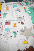 Load image into Gallery viewer, Educational materials about the Constitution with illustrations of the Statue of Liberty, bald eagle, and U.S. flag.
