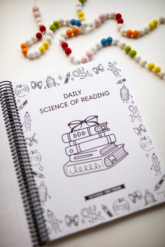 Notebook with 'Daily Science of Reading' design on a white background
