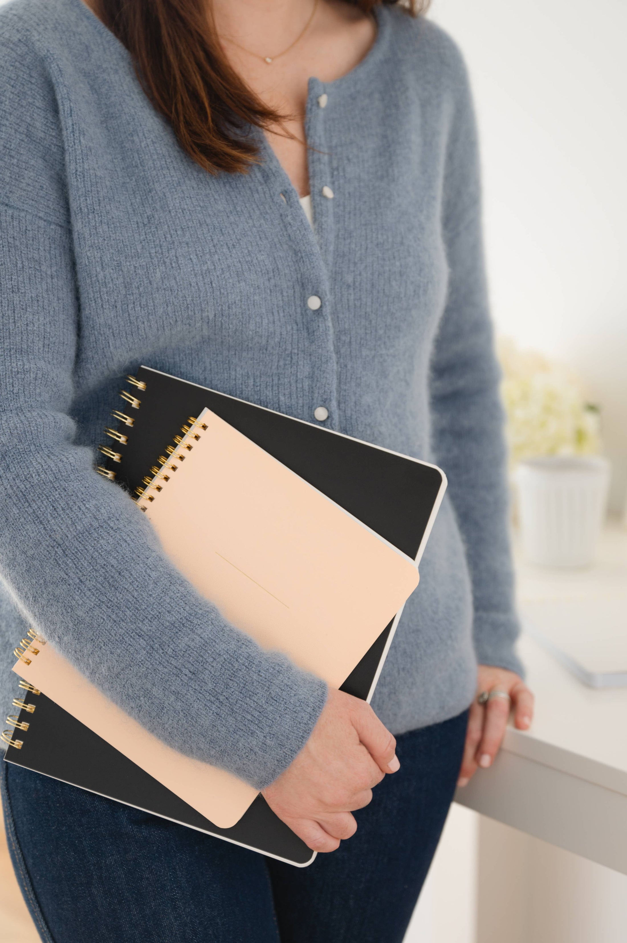 woman holding the Large Black Spiral Notebook